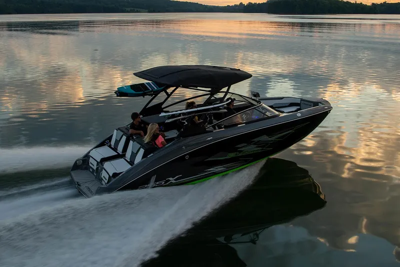 Slide: The Image of 2021 Yamaha Boats 255XD on trailer, sleek black design, parked outdoors. - 7