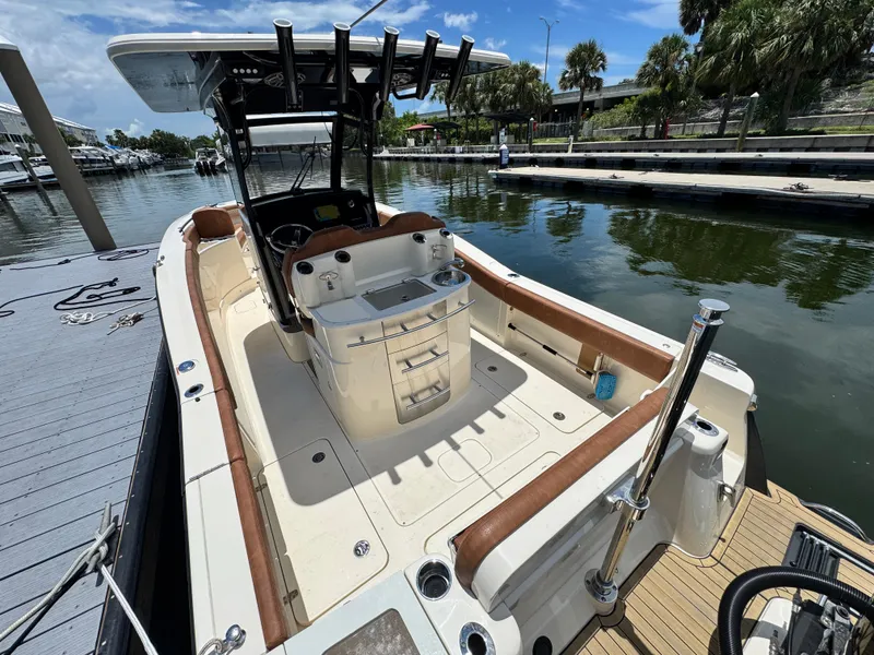 Slide: The Image of 2024 Scout 277 LXF boat docked, featuring spacious deck and modern amenities. - 10