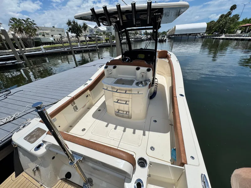 Slide: The Image of 2024 Scout 277 LXF boat docked, featuring spacious deck and modern amenities. - 11
