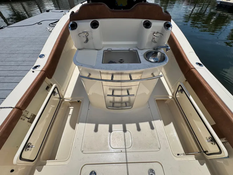 Slide: The Image of 2024 Scout 277 LXF boat interior with sink and storage compartments. - 16