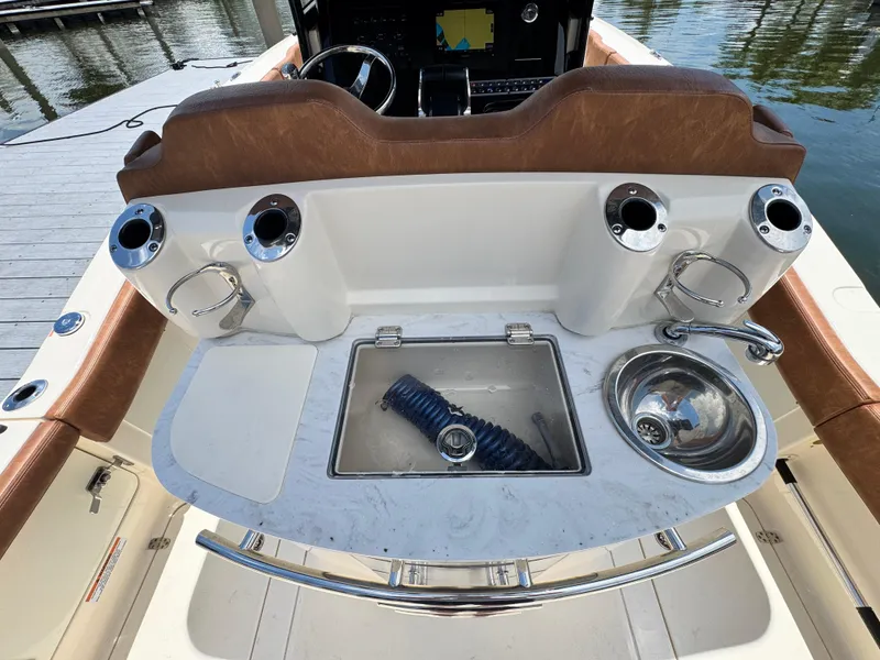 Slide: The Image of 2024 Scout 277 LXF boat interior with sink and storage area. - 17
