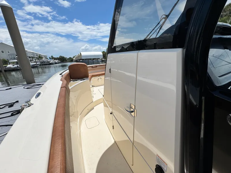 Slide: The Image of 2024 Scout 277 LXF boat docked, showcasing sleek design and luxurious seating. - 22