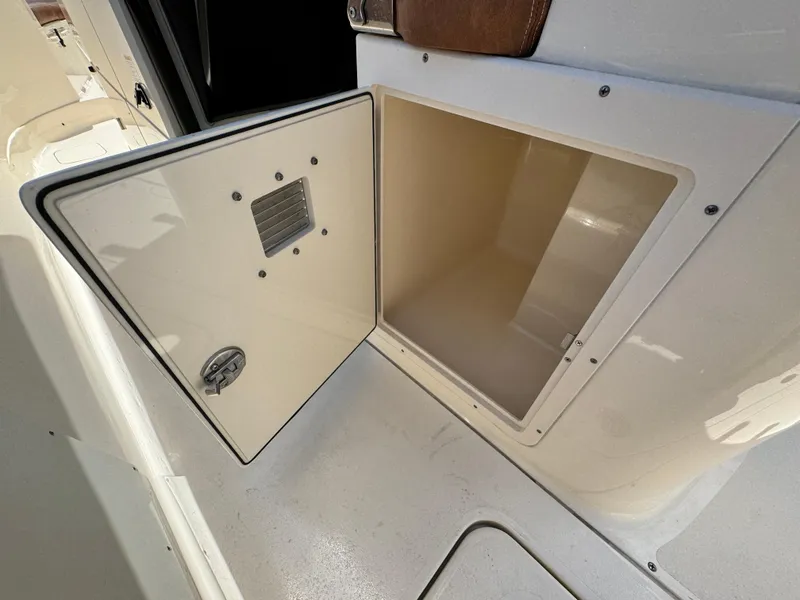 Slide: The Image of Open storage compartment on 2024 Scout 277 LXF boat, showcasing interior space. - 33