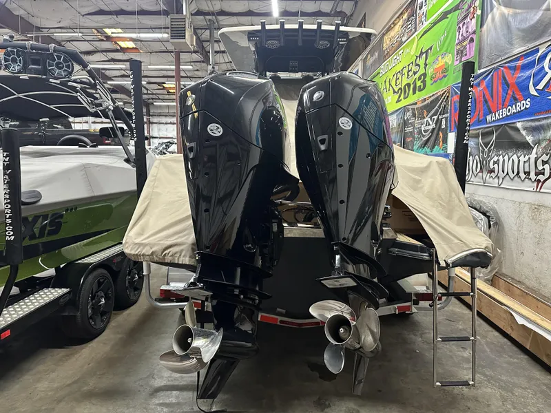 Slide: The Image of 2024 Scout 277 LXF boat with dual outboard motors in a showroom. - 39