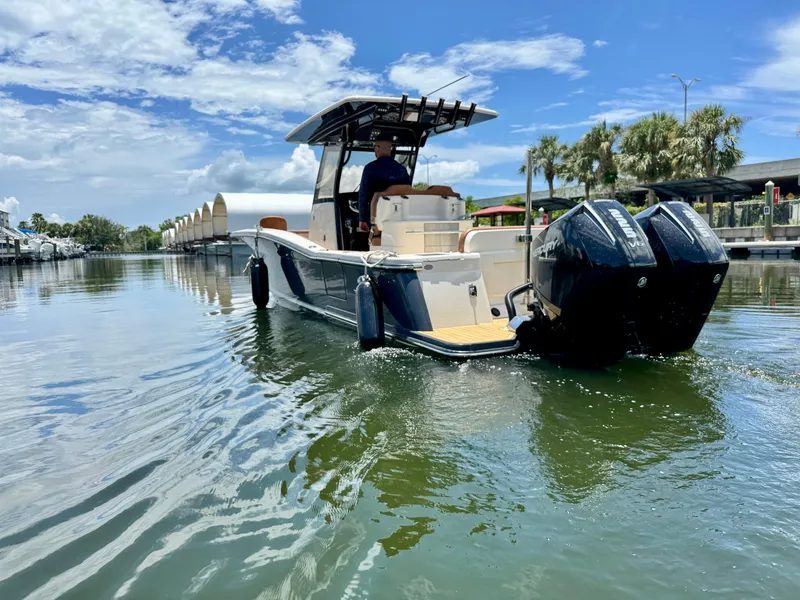 Slide: The Image of 2024 Scout 277 LXF boat cruising on a sunny day with clear skies. - 8