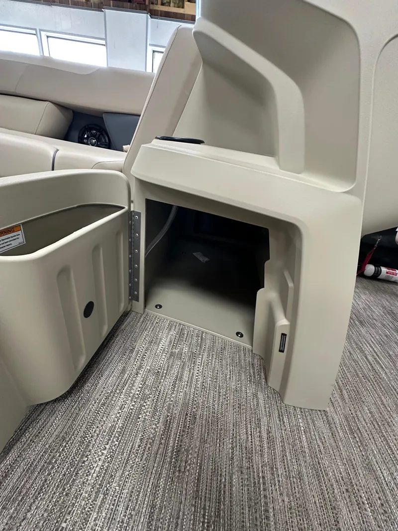 Slide: The Image of 2025 Godfrey Sweetwater 2086 SBC storage compartment with beige interior and carpeted flooring. - 11