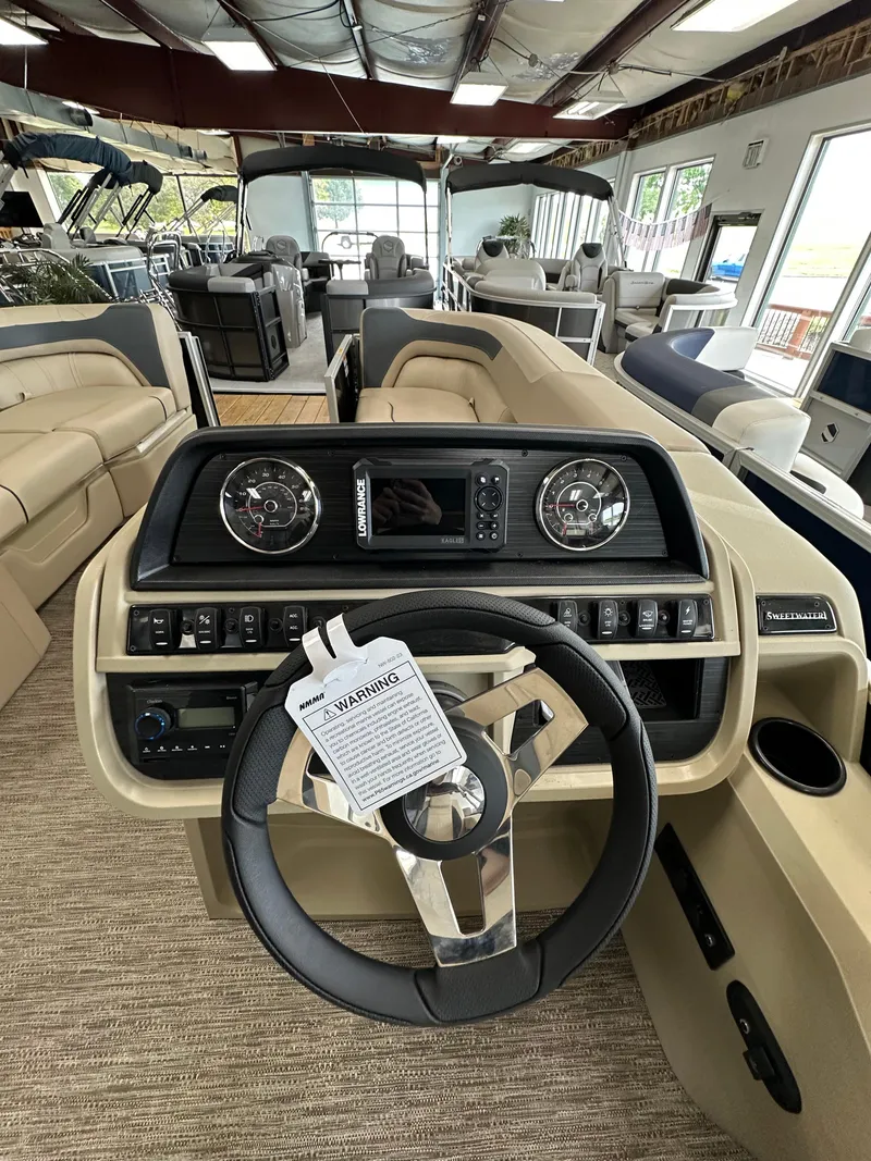 Slide: The Image of Interior view of 2025 Godfrey Sweetwater 2086 SBC boat, featuring steering wheel and dashboard controls. - 4
