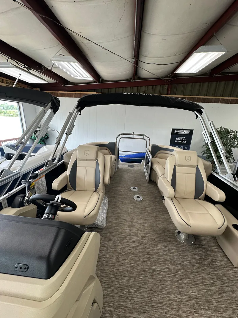 Slide: The Image of 2025 Godfrey Sweetwater 2086 SBC pontoon boat interior with beige seating and steering console. - 5