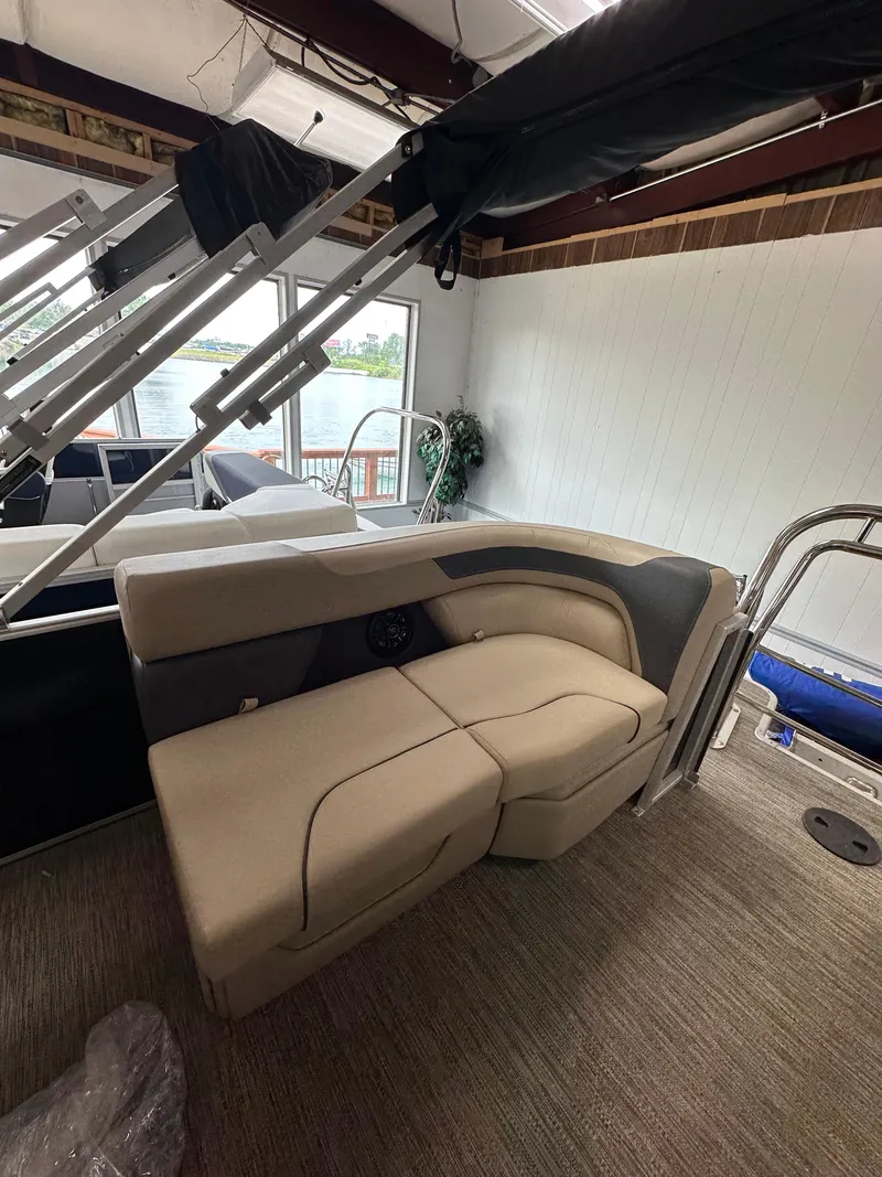 Slide: The Image of 2025 Godfrey Sweetwater 2086 SBC boat interior with beige seating and modern design. - 6