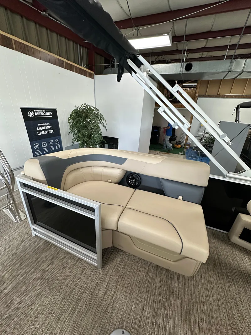 Slide: The Image of 2025 Godfrey Sweetwater 2086 SBC boat interior with beige seating and Mercury signage. - 7