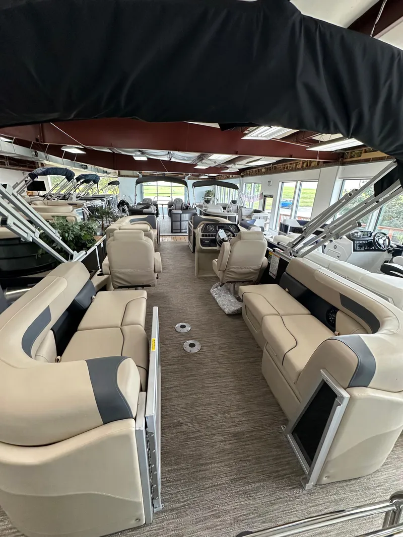 Slide: The Image of 2025 Godfrey Sweetwater 2086 SBC pontoon boat interior with beige seating and modern design. - 8