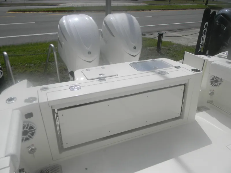 Slide: The Image of 2025 Cobia 285 Center Console boat with dual outboard engines, rear deck view. - 19