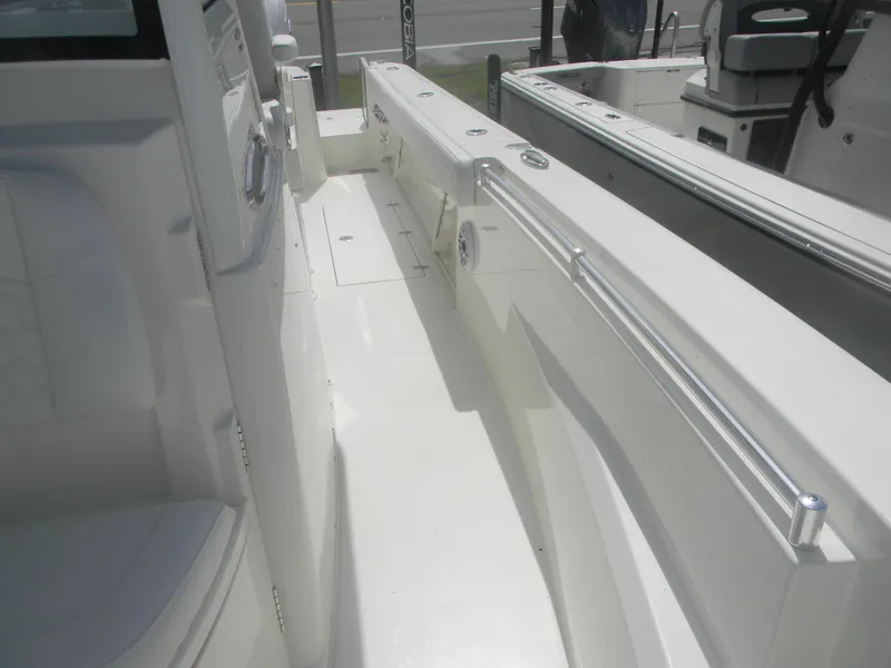 Slide: The Image of 2025 Cobia 285 Center Console boat interior, featuring sleek white deck and seating. - 23