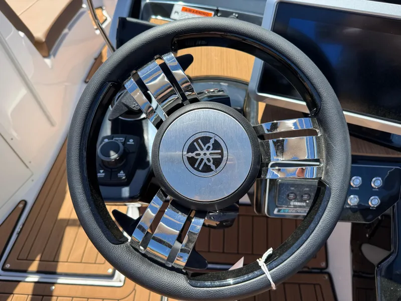 Slide: The Image of Steering wheel of 2025 Yamaha Boats 222SD, featuring sleek design and modern controls. - 17