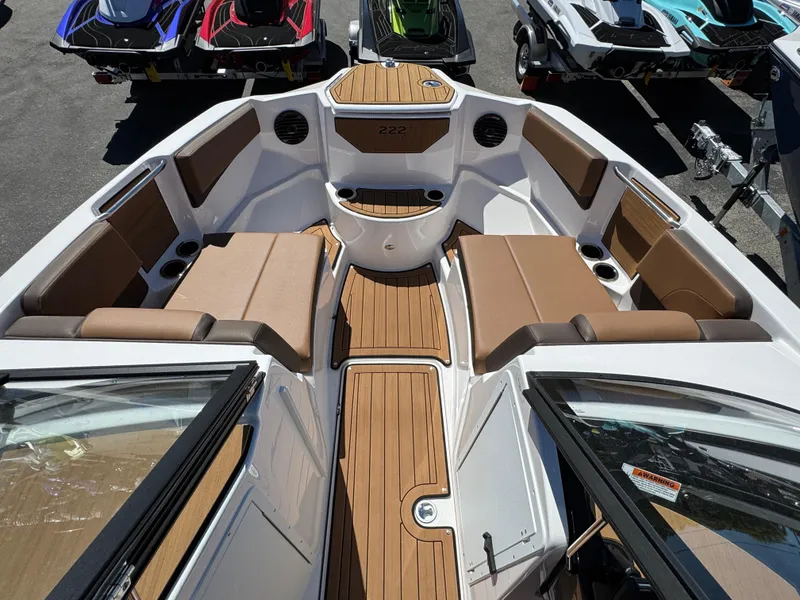 Slide: The Image of 2025 Yamaha Boats 222SD interior with brown seating and wood accents. - 20