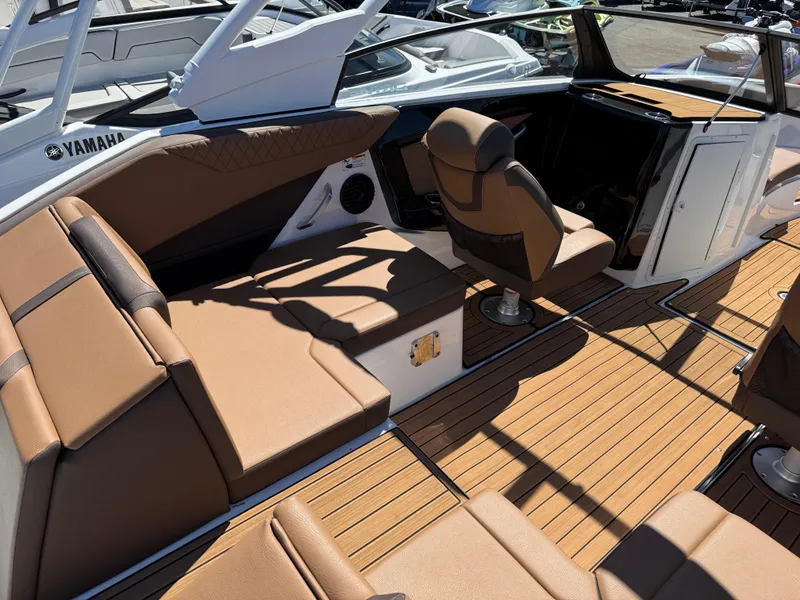 Slide: The Image of 2025 Yamaha Boats 222SD interior with brown seating and sleek design. - 5