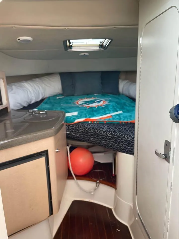 Slide: The Image of Interior of a 2000 Boston Whaler 28 Conquest with bed and cushions. - 10