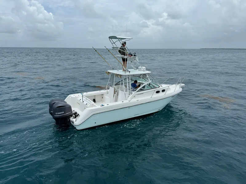 Slide: The Image of Boston Whaler 28 Conquest 2000 on open sea under cloudy sky. - 2