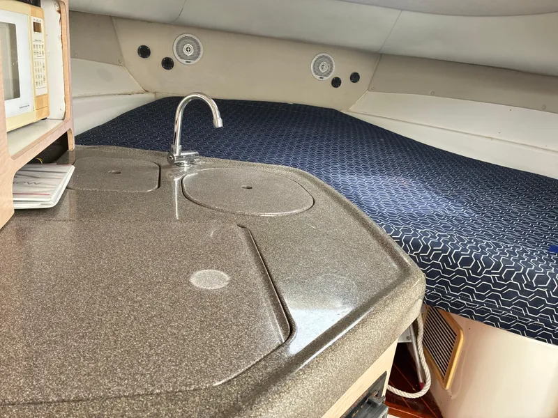 Slide: The Image of Interior of 2000 Boston Whaler 28 Conquest with kitchenette and sleeping area. - 9