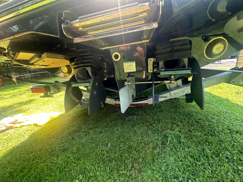 Slide: The Image of Rear view of a 2021 Yamaha Boats 255XD on grass, showcasing its dual jet propulsion system. - 22