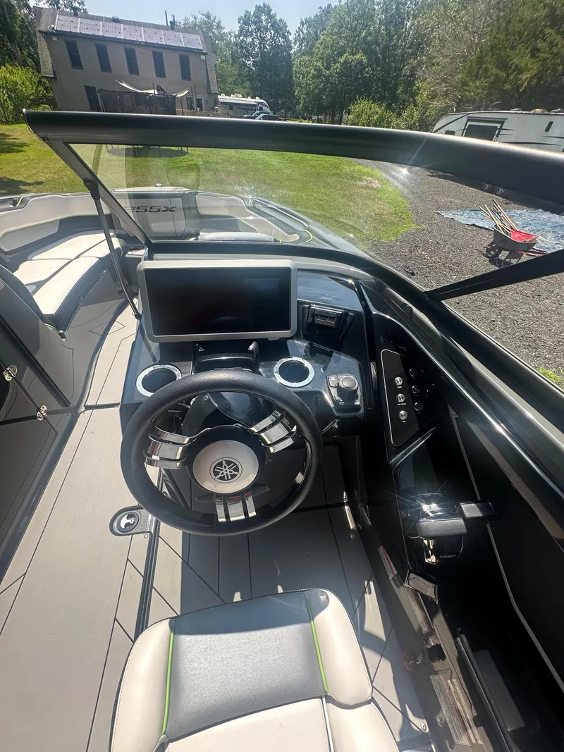 Slide: The Image of 2021 Yamaha Boats 255XD cockpit with steering wheel and dashboard controls. - 5