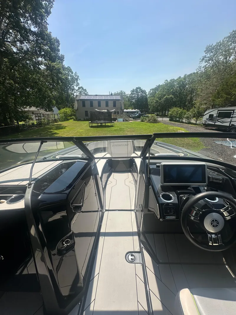 Slide: The Image of 2021 Yamaha Boats 255XD interior view with steering wheel and dashboard. - 7