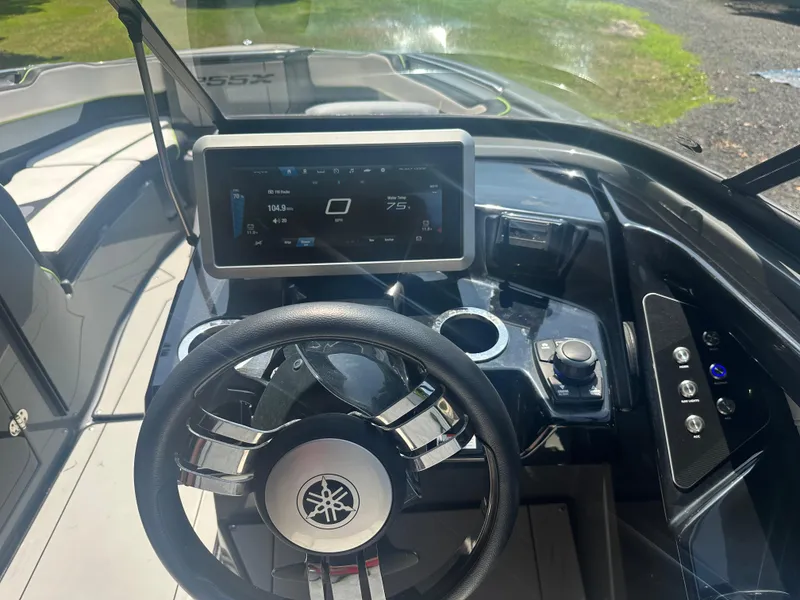 Slide: The Image of 2021 Yamaha Boats 255XD dashboard with steering wheel and digital display. - 9