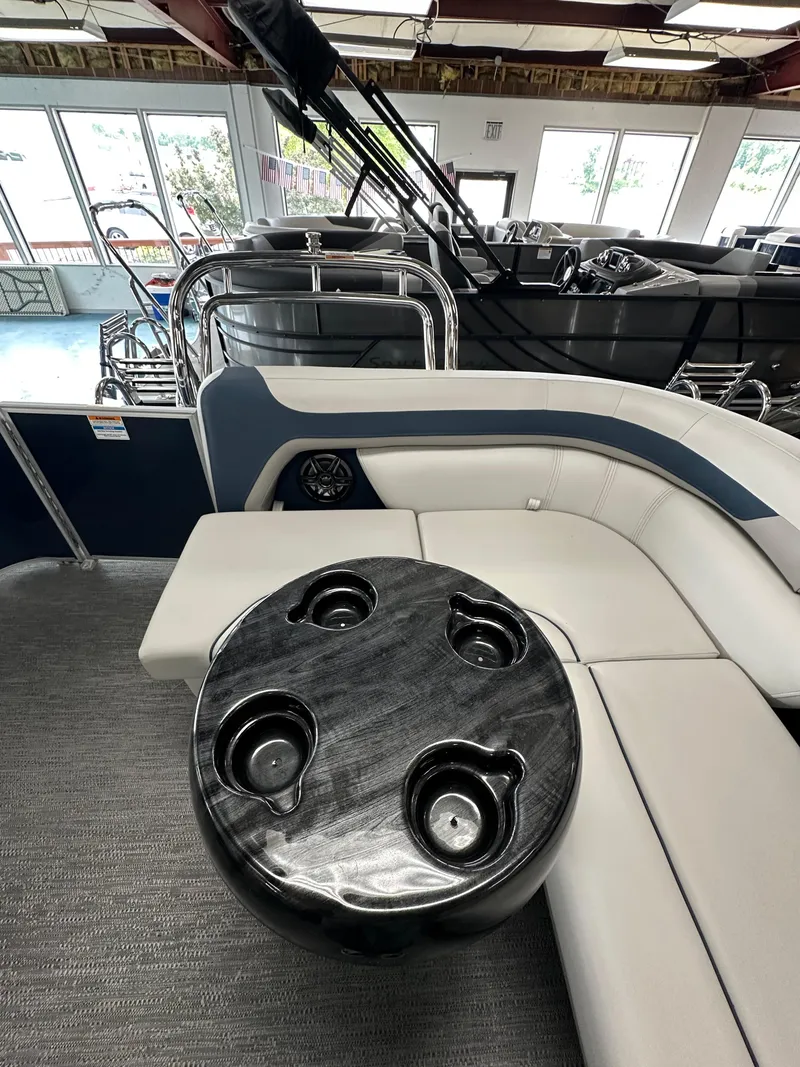 Slide: The Image of Luxurious seating area on 2025 Godfrey Sweetwater 2286 C pontoon boat with sleek table design. - 10