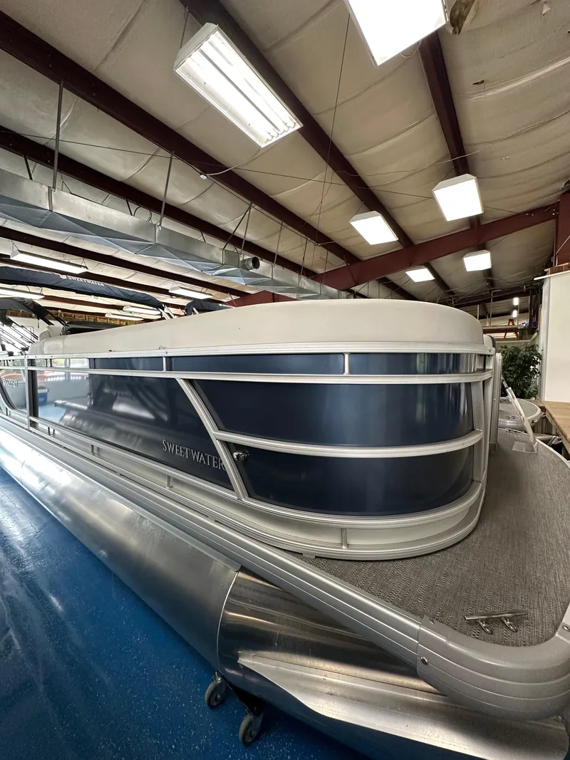 Slide: The Image of 2025 Godfrey Sweetwater 2286 C pontoon boat in showroom, side view. - 17