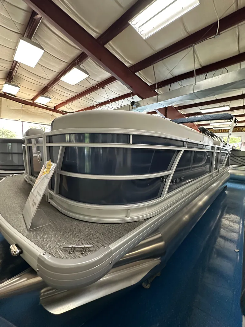 Slide: The Image of 2025 Godfrey Sweetwater 2286 C SPEC EDI TRI pontoon boat displayed indoors. - 18