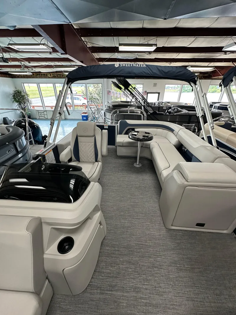 Slide: The Image of 2025 Godfrey Sweetwater 2286 C pontoon boat interior with plush seating and modern design. - 5