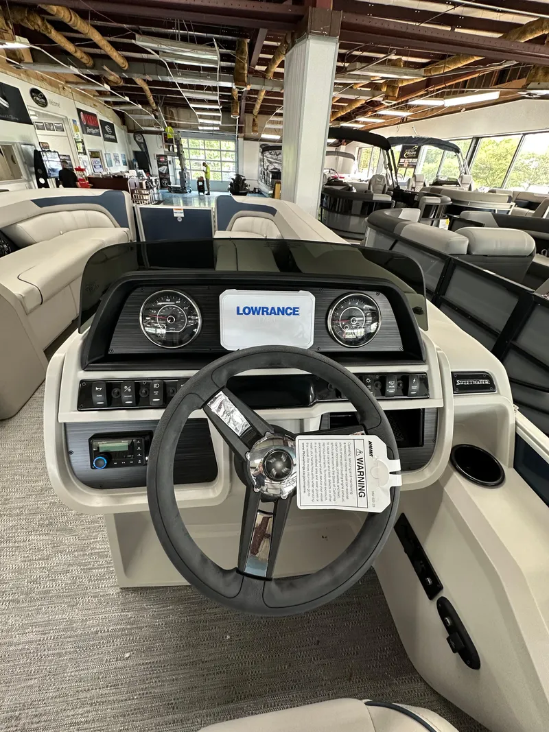 Slide: The Image of 2025 Godfrey Sweetwater 2286 C SPEC EDI TRI boat dashboard with steering wheel and controls. - 6