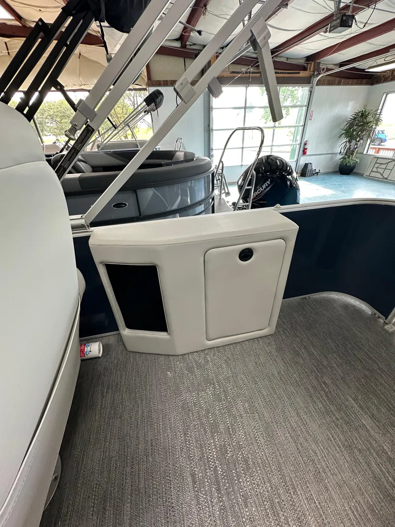 Slide: The Image of 2025 Godfrey Sweetwater 2286 C SPEC EDI TRI interior with seating and storage compartment. - 8