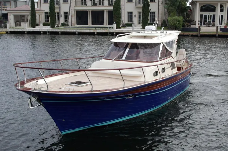 Slide: The Image of 2023 Fratelli Aprea Sorrento Cabinatto 32 yacht on water near luxury homes. - 1