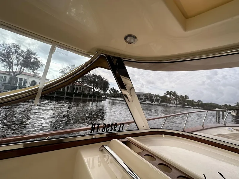 Slide: The Image of View from inside a 2023 Fratelli Aprea Sorrento Cabinatto 32 boat, overlooking a serene waterfront. - 10