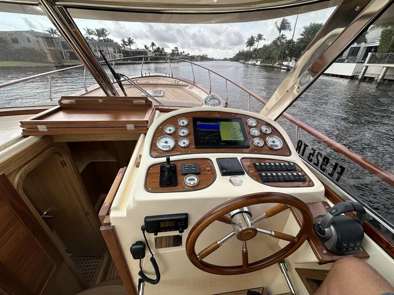 Slide: The Image of Fratelli Aprea Sorrento Cabinatto 32, 2023 model, boat cockpit with navigation controls on a waterway. - 15