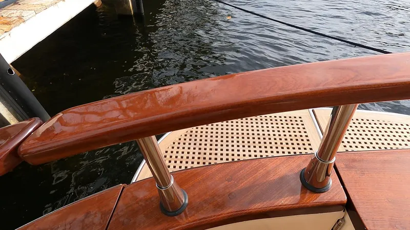 Slide: The Image of Fratelli Aprea Sorrento Cabinatto 32, 2023 model, wooden deck and railing detail by the water. - 17