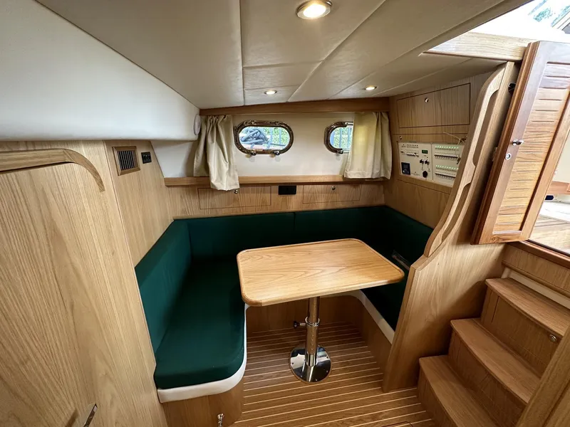 Slide: The Image of Interior of 2023 Fratelli Aprea Sorrento Cabinatto 32 with wooden furnishings and green seating. - 23