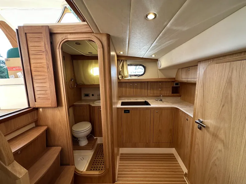 Slide: The Image of 2023 Fratelli Aprea Sorrento Cabinatto 32 interior with wooden cabinetry and compact kitchen. - 25