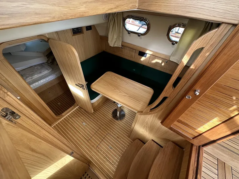 Slide: The Image of Fratelli Aprea Sorrento Cabinatto 32, 2023 model, luxurious wooden cabin interior with table and seating. - 30