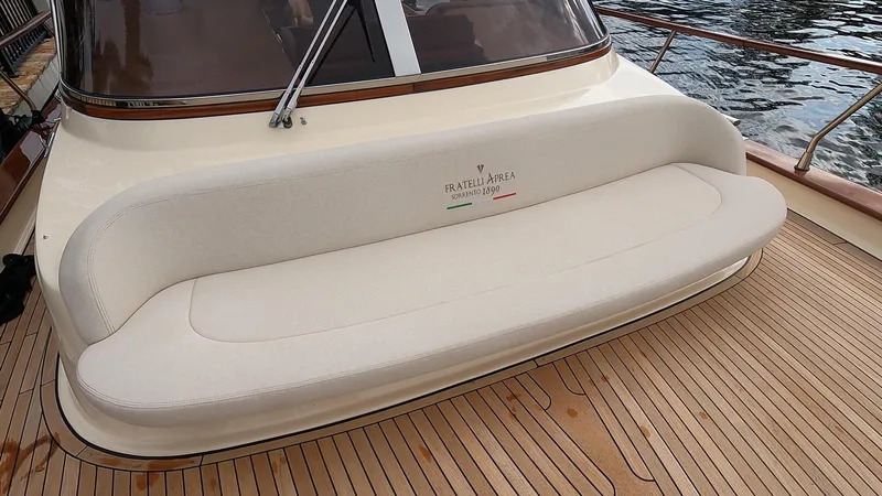Slide: The Image of Fratelli Aprea Sorrento Cabinatto 32, 2023 model, beige cushioned seating on wooden deck. - 41