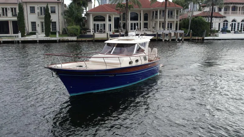 Slide: The Image of 2023 Fratelli Aprea Sorrento Cabinatto 32 yacht cruising near luxury waterfront homes. - 5