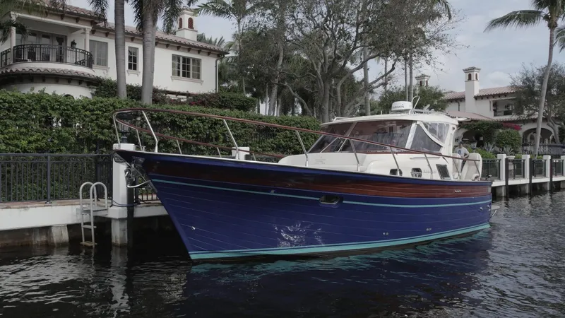 Slide: The Image of 2023 Fratelli Aprea Sorrento Cabinatto 32 yacht docked by waterfront homes. - 6