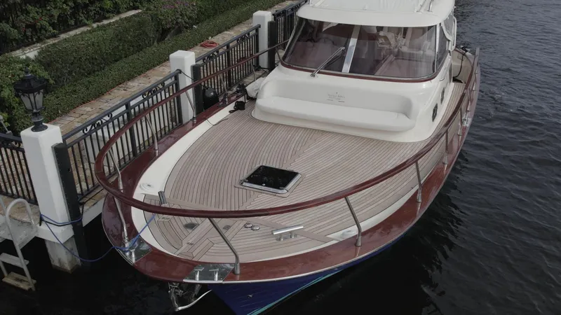 Slide: The Image of 2023 Fratelli Aprea Sorrento Cabinatto 32 docked, showcasing elegant wooden deck and sleek design. - 7
