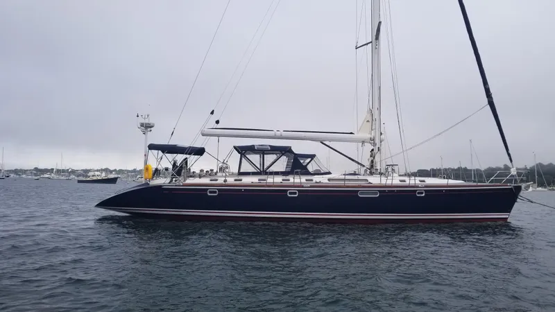 The Image of Sleek 2003 CNB 64 yacht on calm waters, overcast sky in the background. - 0