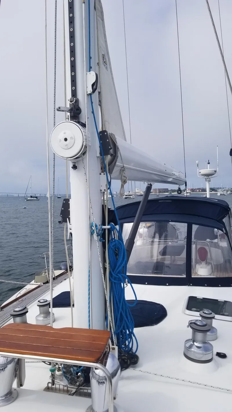 Slide: The Image of Sailing yacht CNB 64, 2003 model, with blue canopy, anchored in a busy harbor. - 16