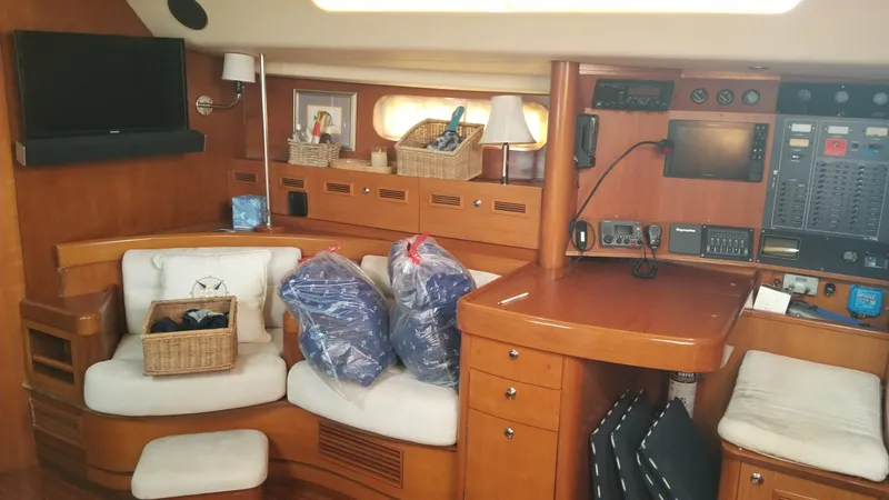 Slide: The Image of Sailing yacht CNB 64, 2003 model, on calm waters with visible deck and distant boats. - 17