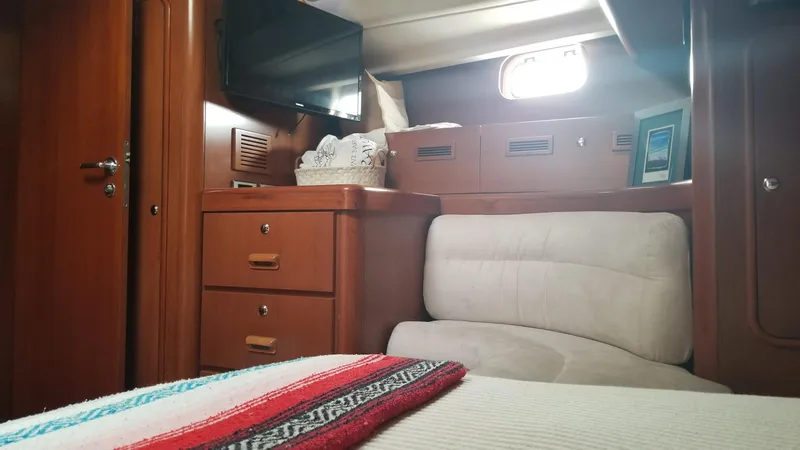 Slide: The Image of Bow of 2003 CNB 64 yacht with teak decking on calm water. - 19