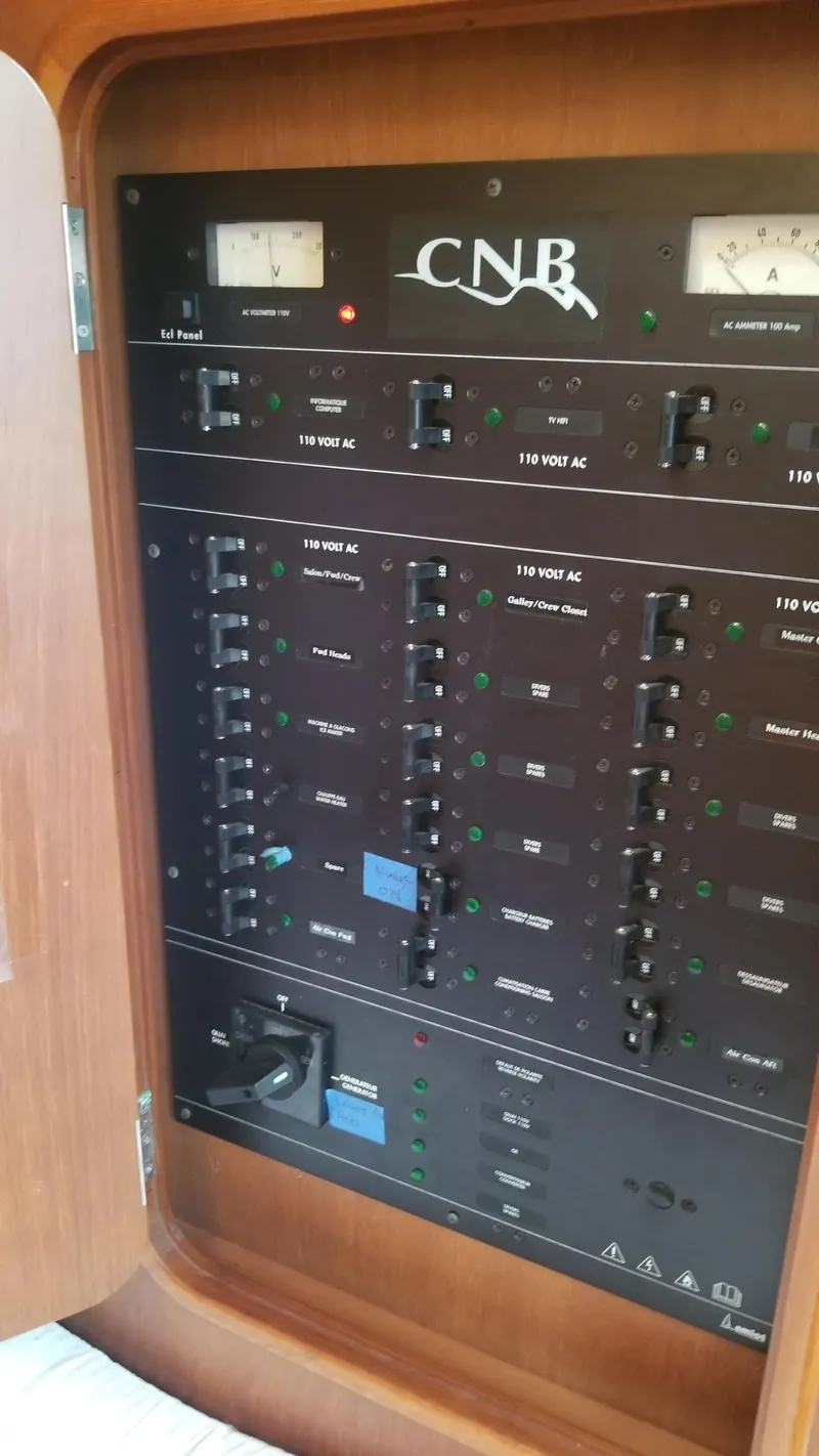 Slide: The Image of Luxurious CNB 64 yacht interior with wooden table, cushioned seating, and nautical decor. - 6