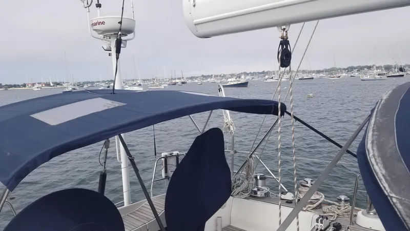 Slide: The Image of Luxurious interior of 2003 CNB 64 yacht with seating, navigation equipment, and storage baskets. - 8